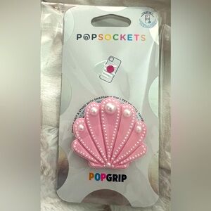 Pink shell pop socket. New in original packaging.